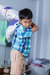 An aggressive asian child. Boy looking furious. Negative human face expressions concept.