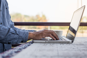 working on laptop, close up of hands of business man.