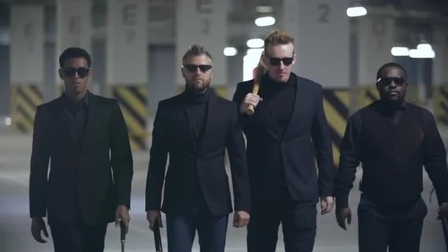 Four brutal gangsters walking with baseball bats in slow motion