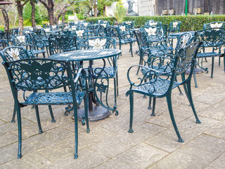 Green steel table and chair set in the garden