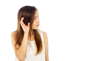 Fototapeta premium young woman with hand behind ear listening