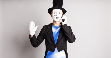 Man mime  talking on his cell phone. April Fool's Day concept.