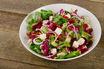 Healthy salad with feta cheese and pomegranate.