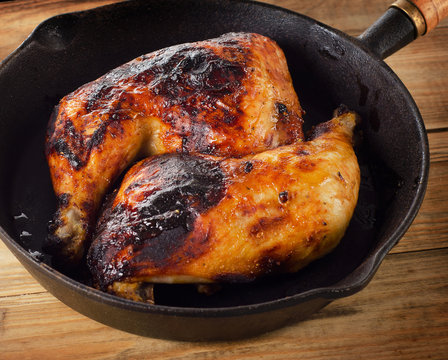Roasted Chicken legs on a vintage cast iron skillet.