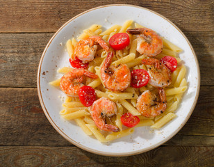 Penne pasta with shrimps and tomatoes.