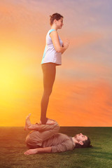 Fototapeta na wymiar The two people doing yoga exercises 