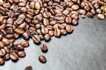 roasted coffee beans on a black background