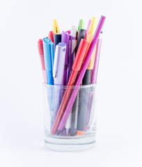 Pens and pencils in a glass jar