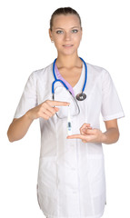 Fototapeta premium Medical female doctor shows in hand digital thermometer