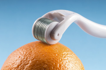 Derma roller for medical micro needling therapy with orange. Tool also known as: Derma roller,...