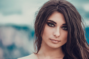 Portrait of beautiful young lady. Outdoors. Smoky eyes.