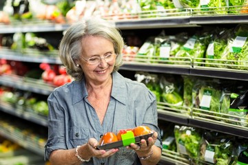 Senior woman picking out some vegetables