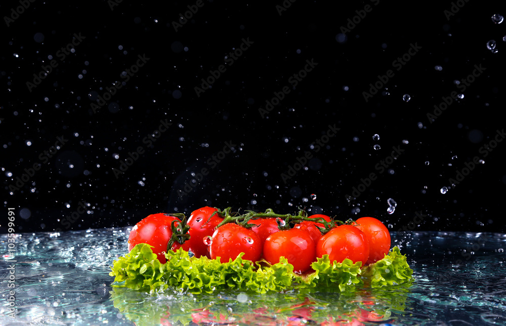 Wall mural Fresh tomato cherry and green fresh salad with water drop splash on dark background Macro drops of water fall on the red cherry tomatoes and make splash