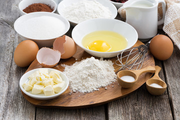 prepared baking ingredients on wooden table, horizontal