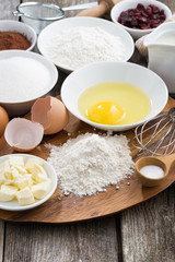 prepared baking ingredients on wooden table, vertical