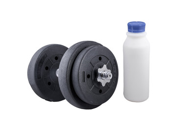 Milk in a glass and Big black dumbells ,over white background