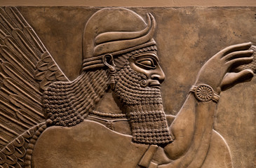 Ancient relief of an assyrian god - obrazy, fototapety, plakaty