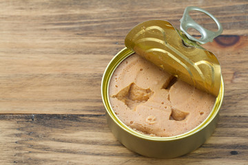 fish pate in iron box on brown wooden background