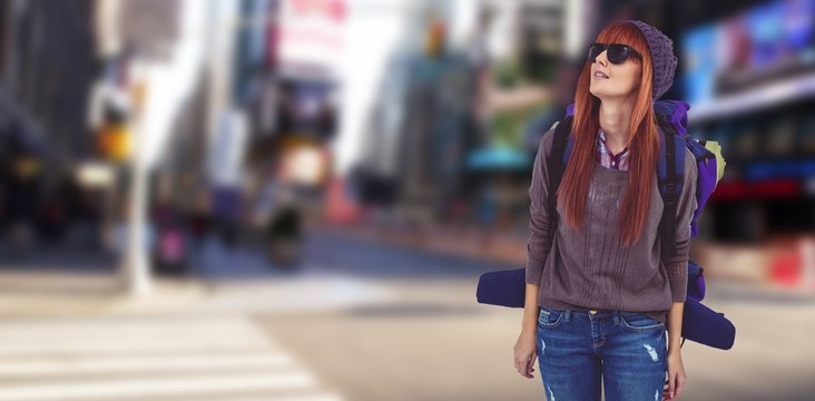 Composite image of portrait of a hipster woman with a travel bag