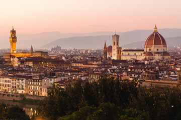 Fototapeta na wymiar Panoramic view to the river Arno, with Ponte Vecchio, Palazzo Vecchio and Cathedral of Santa Maria del Fiore (Duomo) at dusk time. Florence, Italy
