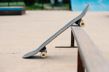 Old used skateboard on the ground at skatepark.  © pio3