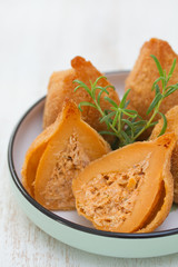 portuguese dish coxinhas de frango on plate on white wooden background