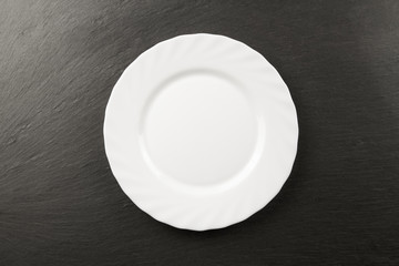 white plate on a black background. Table setting
