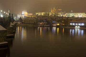 Night romantic snowy Prague gothic Castle with Charles Bridge, Czech republic