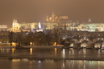 Fototapeta na wymiar Night romantic snowy Prague gothic Castle with Charles Bridge, Czech republic