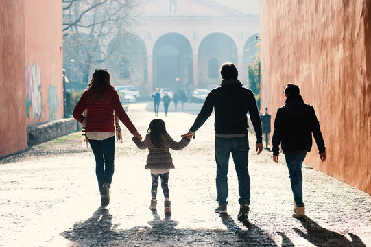 Happy family walking together in the city.
