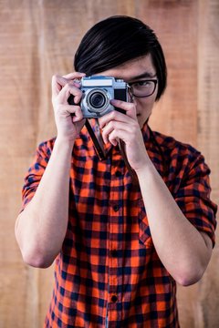 Hipster taking pictures with an old camera 