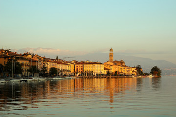  View of the promenade of Lake Garda, lit by the sun..