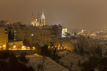 Fototapeta na wymiar Night snowy foggy Prague City with gothic Castle, Czech republic
