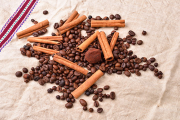 Coffee beans, cinnamon sticks and truffles on vintage texture, j