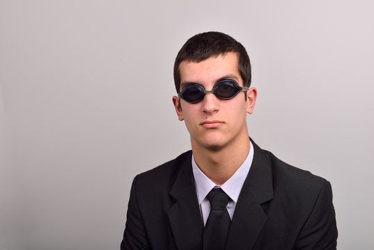 Successful businessman wearing goggles for water, thinking at va