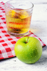 Green apple and glass of juice