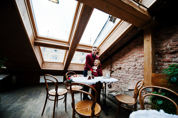Young beautiful stylish couple in a red dress in love story at t