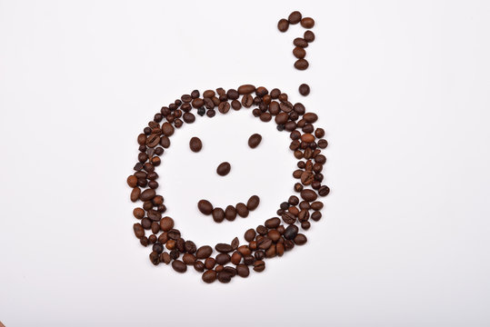 Picture of a smiley face with question mark made of coffee beans