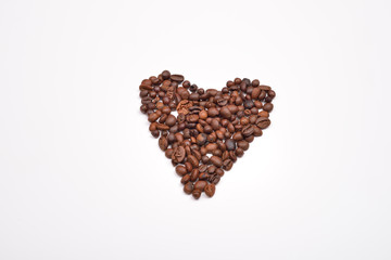 Roasted coffee beans in the shape of the heart. Concept of lovin
