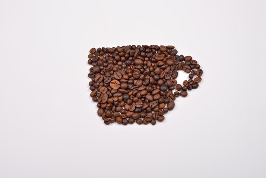 Coffee cup image made up of coffee beans on a white background