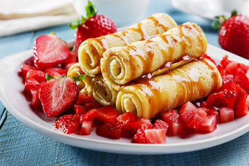 rolled pancakes with strawberries and caramel breakfast