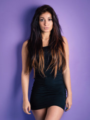 Fototapeta premium Beautiful woman portrait against colorful purple background.