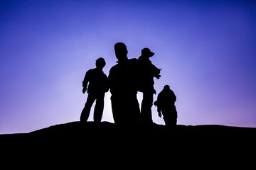 Fototapeta na wymiar Hikers with backpacks enjoying sunset view
