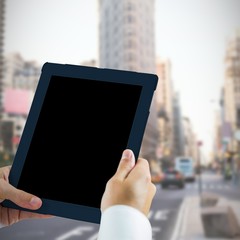 Man using tablet pc against new york street