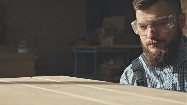 Experienced Carpenter checks the quality of the boards by hand. RAW video record.