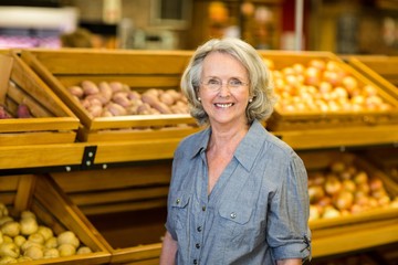 Smiling senior woman at the grocery shop
