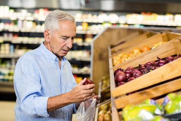 Senior man picking out onions