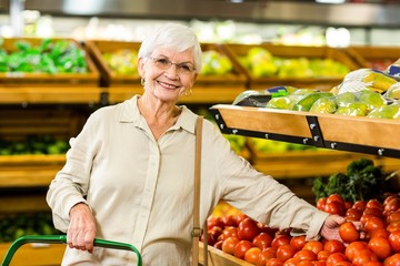 Senior woman picking out some vegetables