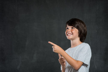 Boy pointing at copy space