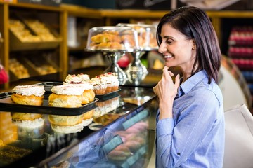 Pretty smiling woman choosing her dessert